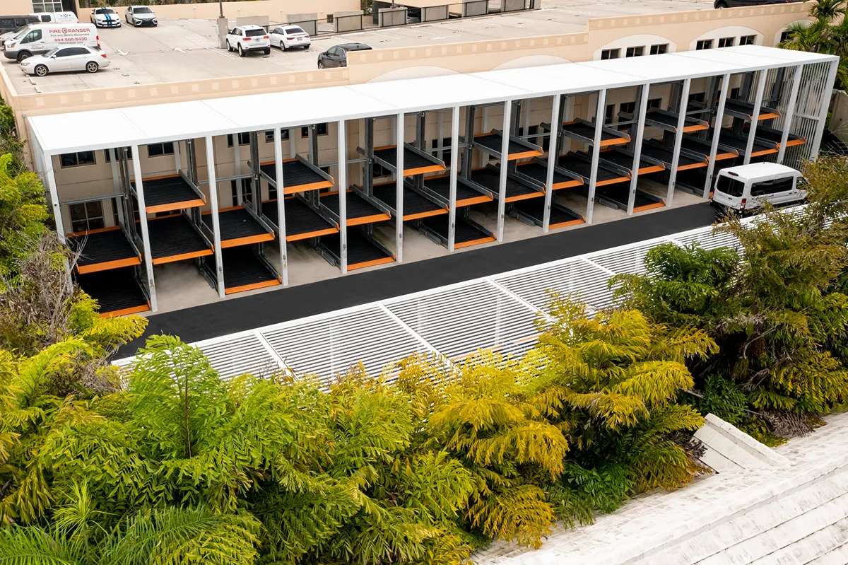 Space-saving dual-level parking system with compact aluminum canopy structure designed by SYZYGY Global.