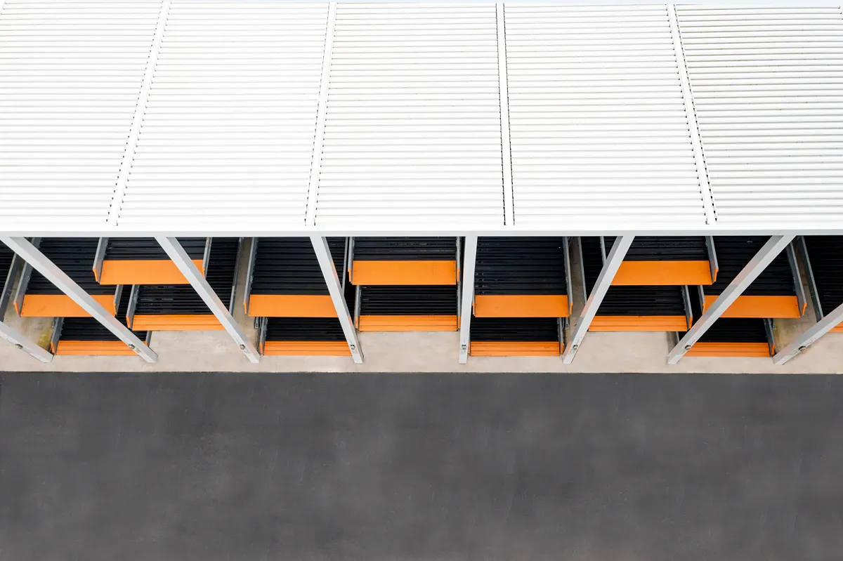 Close-up of commercial parking structure with powder-coated aluminum canopy and precision-engineered car stackers.