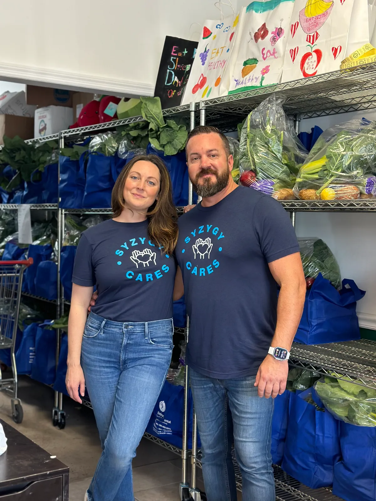 Julie Hawbaker and Jason Herring volunteering for Eat Better Live Better, supporting local families with fresh food.