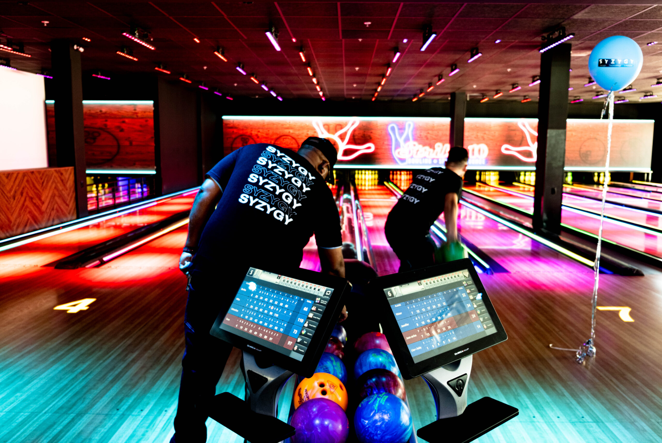 SYZYGY Global team members bowling at Strike 10 during the 8th anniversary celebration.