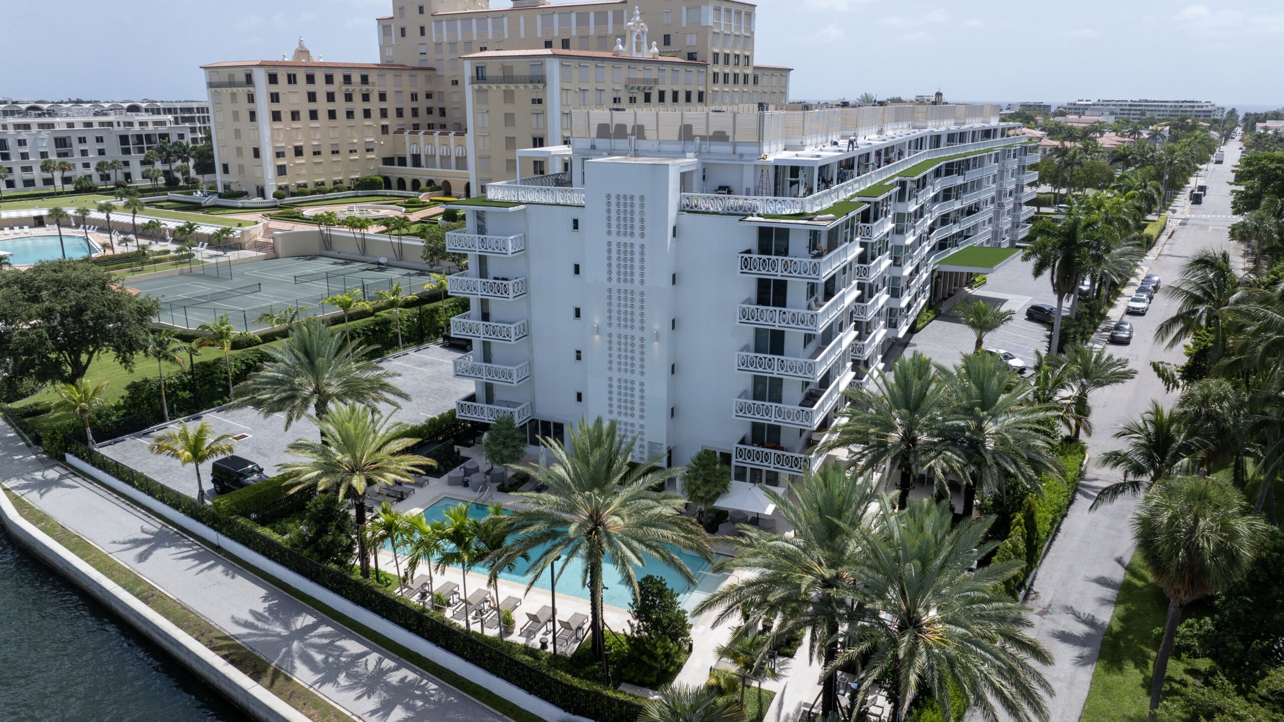 Rooftop R-Blade pergolas at Royal Poinciana apartment complex in Palm Beach create shaded private spaces.