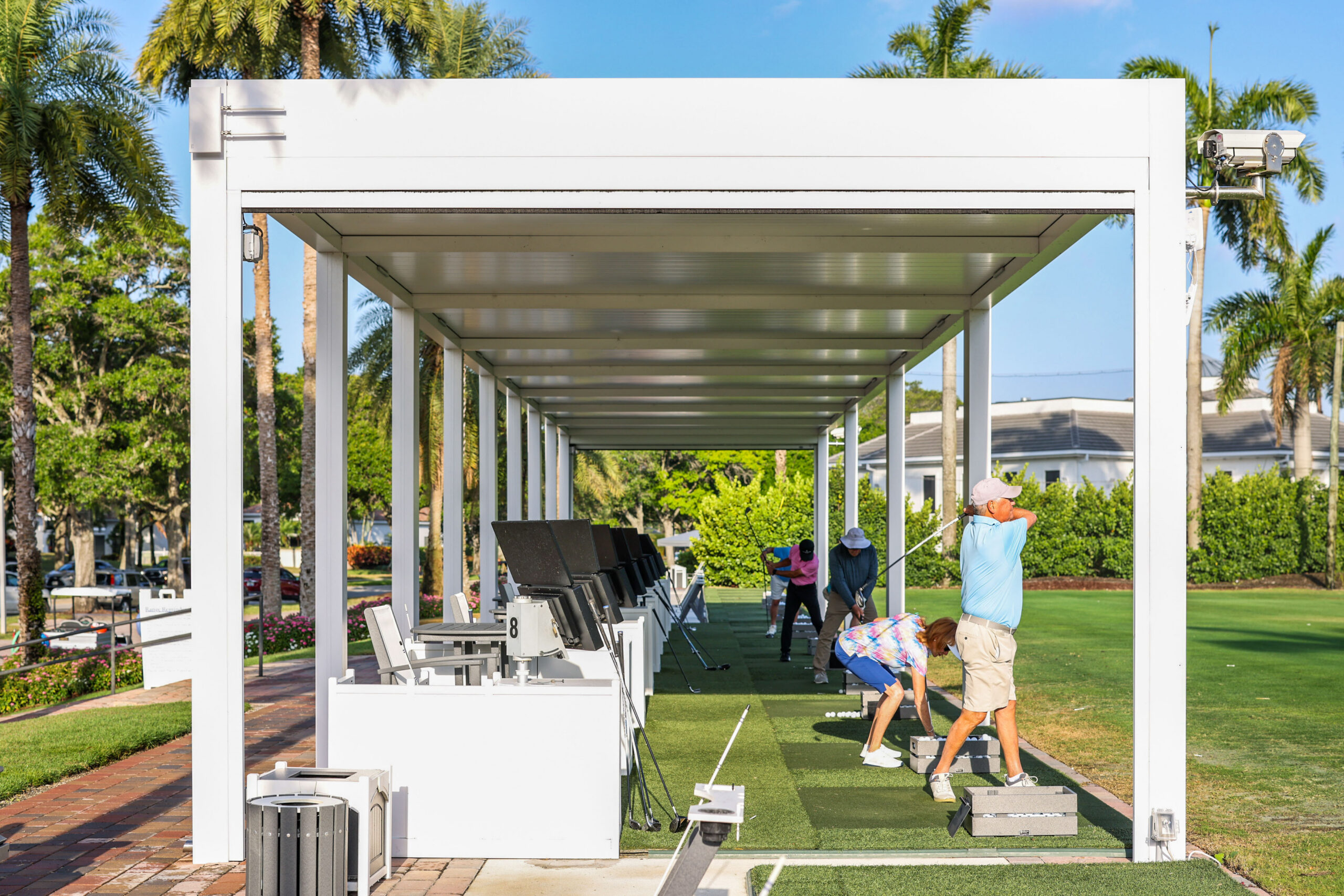 Hurricane-rated pergola covering a golf driving range with durable aluminum structure designed for South Florida conditions.
