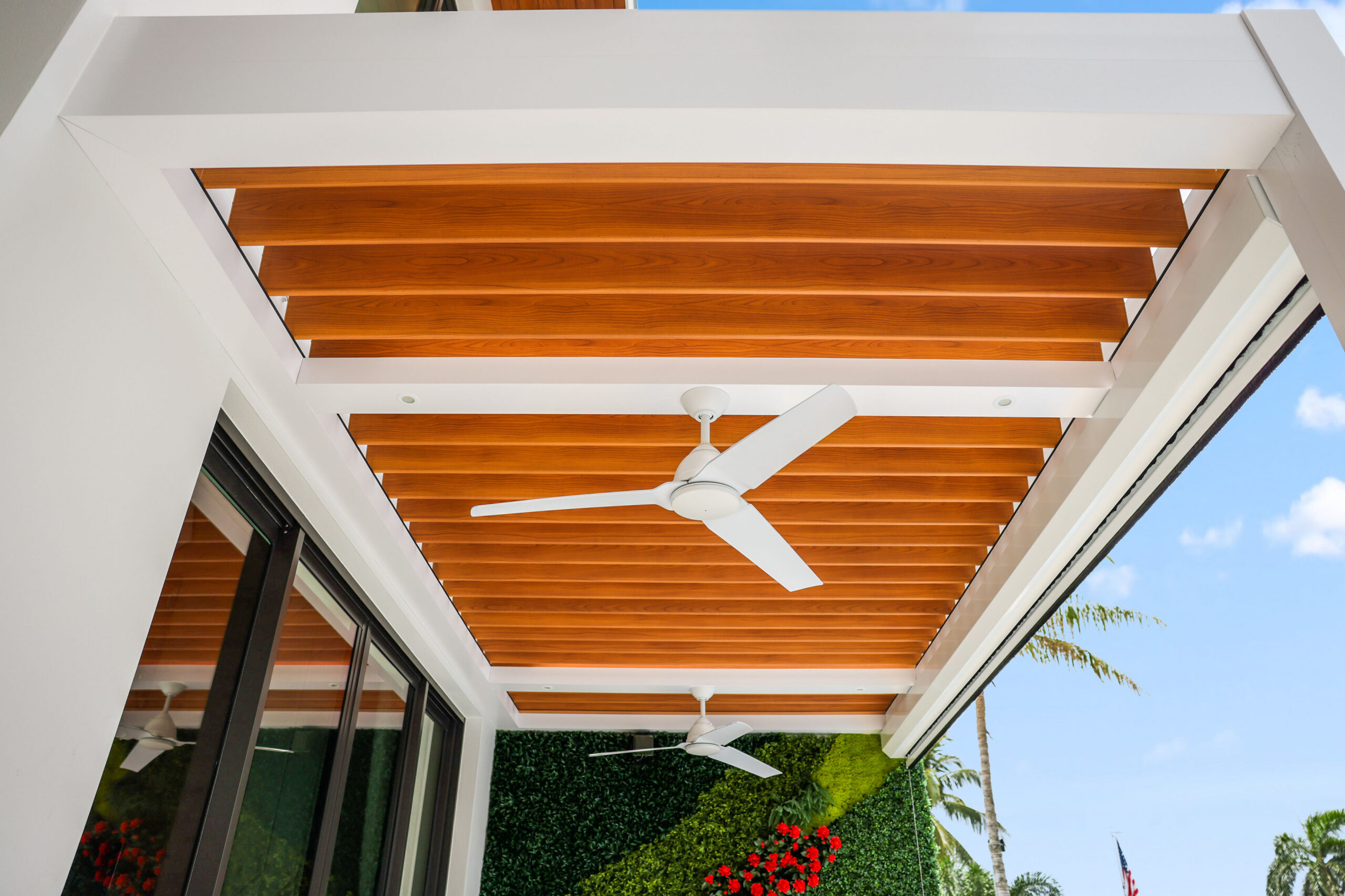 Woodgrain aluminum pergola ceiling with integrated fans, showcasing natural wood look and clean modern lines.