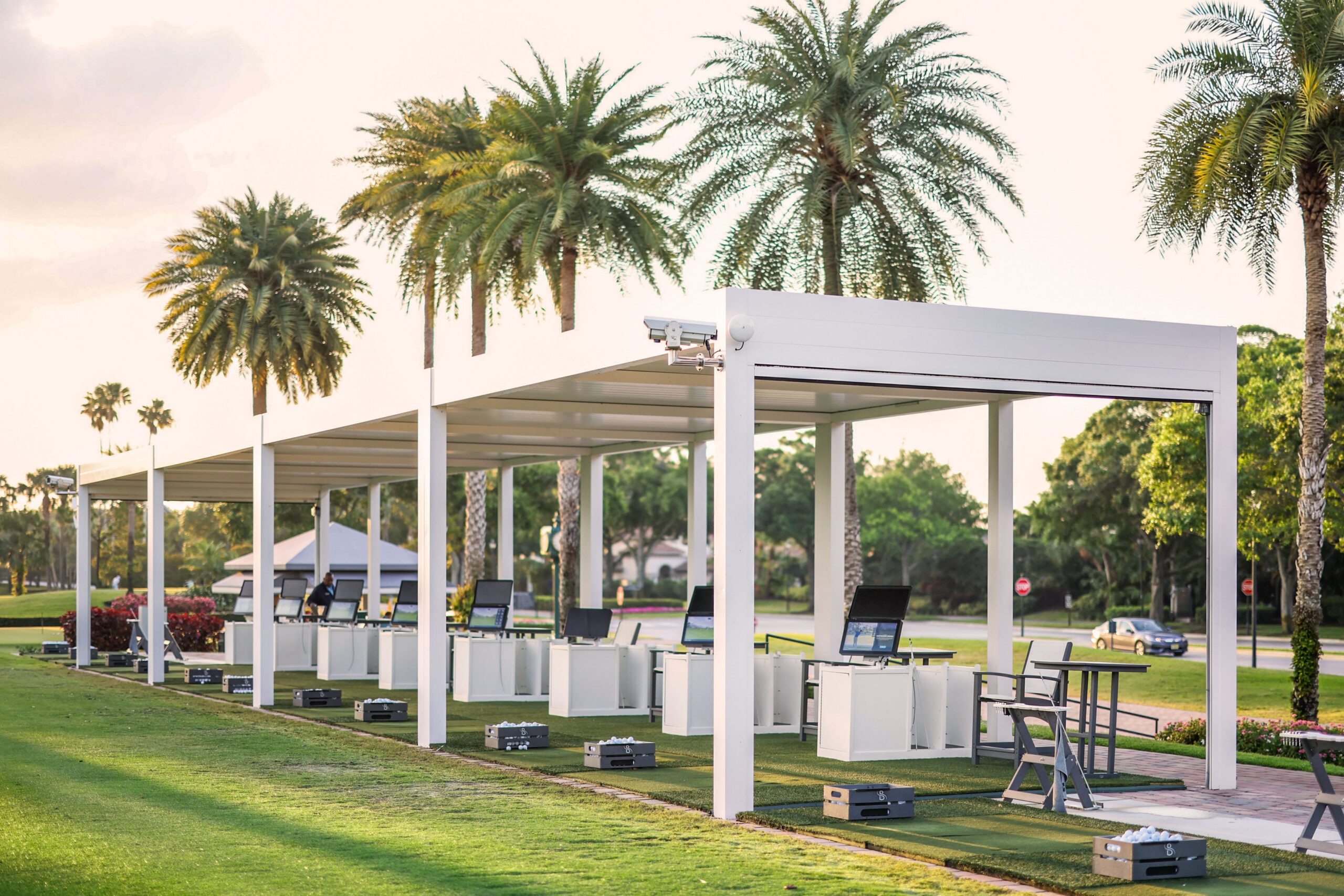Covered golf bay pergola structure with integrated shade at South Florida country club.
