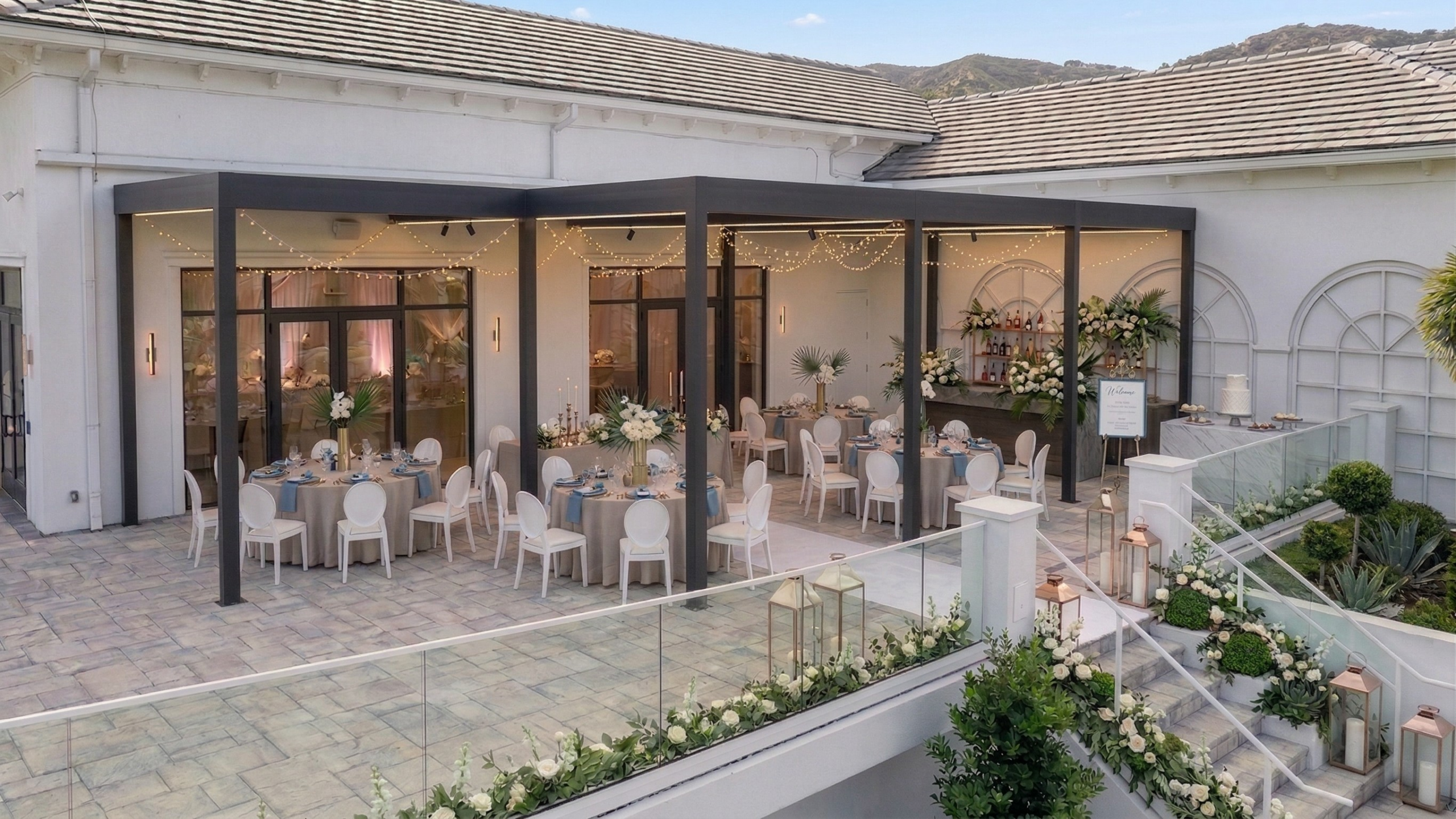 Luxury covered outdoor wedding venue with elegant reception space and architectural rain protection.